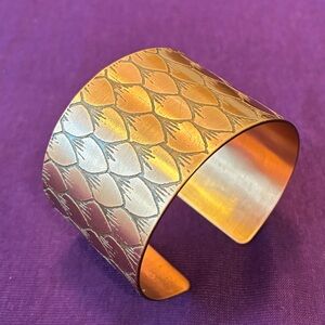 Handmade copper cuff bracelet with leaf design.